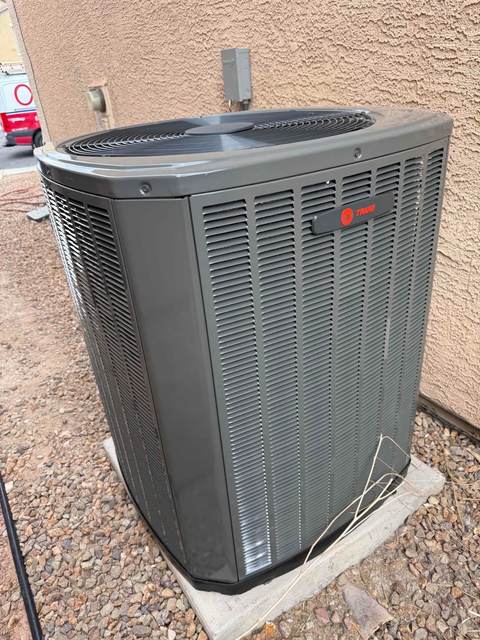 Trane outdoor AC condenser unit with the fan visible on top, the component addressed by this repair